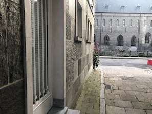 Stunning corner building with a stone facade and arched windows.
