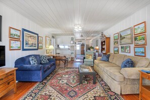 A spacious living room with two sofas, a coffee table, and a rug. - Miller Villa, 6 bedroom, 3 bathrooms, deep water channel (Murrells Inlet)