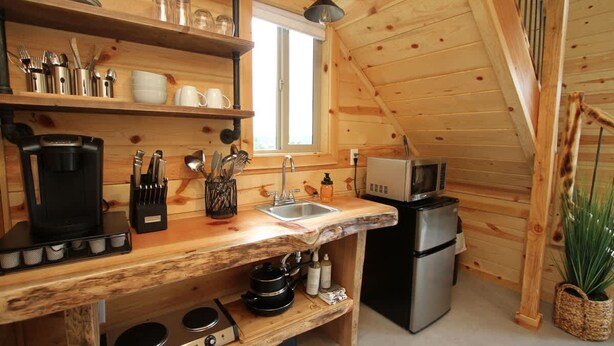 A compact kitchen with a wooden countertop, a sink, a stove, a refrigerator, and a microwave. - Stargazing Treetop near Zion with King Bed (Orderville)