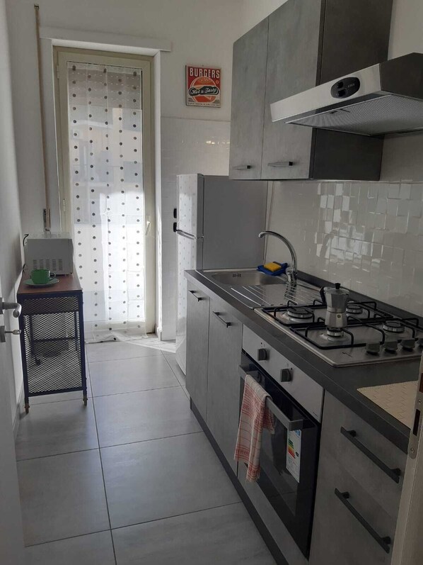 A modern kitchen with stainless steel appliances, a built-in oven, and a gas stove.