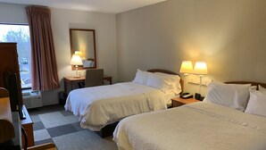 A hotel room with two beds, a desk, a chair, a lamp, and a window with curtains. - Comfort Inn & Suites Mt Holly (Mount Holly)