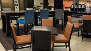 A hotel lobby with a seating area, a bar, and a coffee station. - Comfort Inn & Suites Mt Holly (Mount Holly)