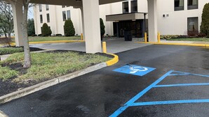 A building entrance with a clear sign indicating "CLEARANCE 14". - Comfort Inn & Suites Mt Holly (Mount Holly)