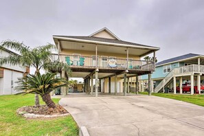 A two-story building with a covered porch and a balcony.