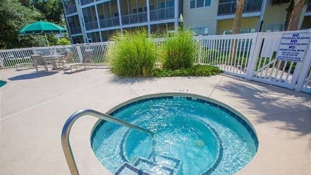 A small, round pool with a metal ladder and a 'No Diving' sign. - Quick Walk to the Beach!! (North Myrtle Beach)