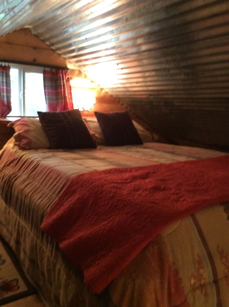 Ein Schlafzimmer mit einem Bett, Kissen und einer Decke.