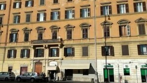 A multi-story building with a consistent architectural style, featuring a series of windows and a ground-level entrance. - Ad 2015 Guesthouse (Rome)