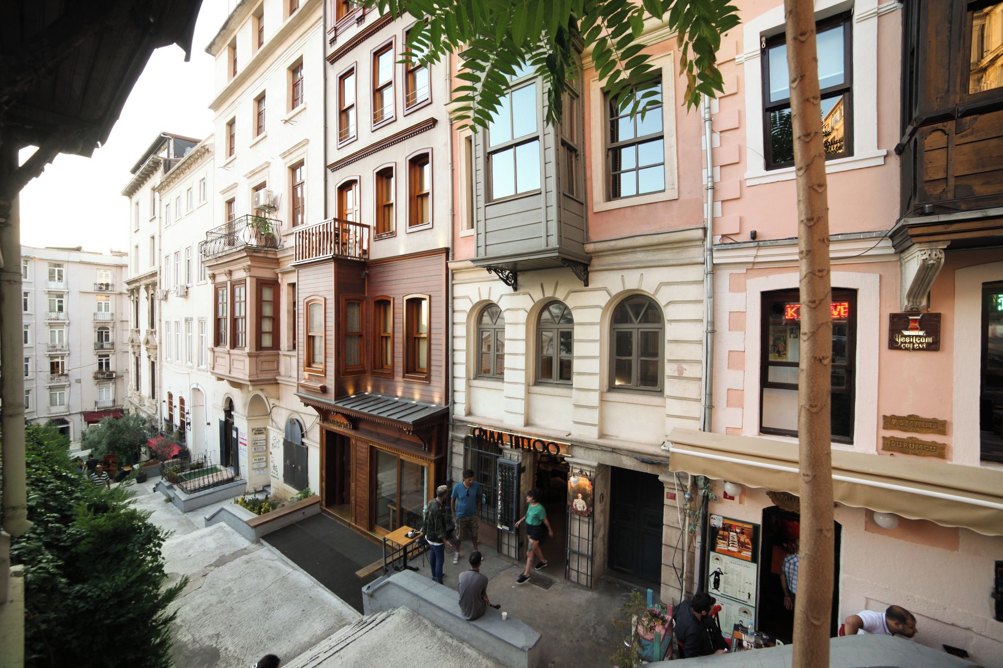A multi-story building with a ground-floor café and a visible restaurant.