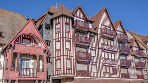 A row of traditional half-timbered houses with steep gabled roofs and multiple balconies. - Apartment Le Hoc by Interhome (Deauville-Trouville)