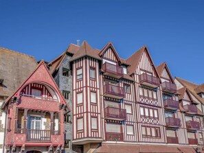 A row of traditional half-timbered houses with steep gabled roofs and multiple balconies. - Apartment Le Hoc by Interhome (Deauville-Trouville)
