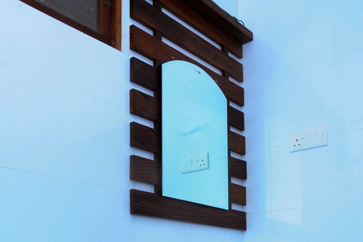 A small, modern bathroom with a toilet, sink, and mirror.