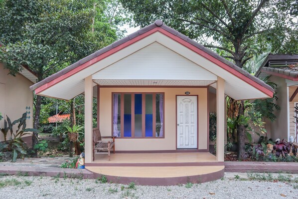 A small house with a porch, a door, and a number '110' on the wall.
