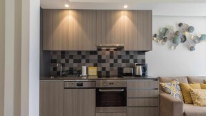 A modern kitchen with wooden cabinets, a tiled backsplash, and a built-in oven.