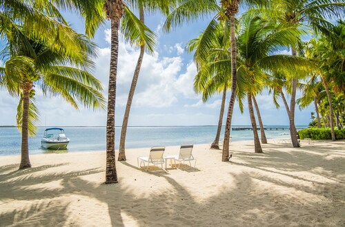 Kaibo Yacht Club 12C - 2nd floor condo with beach views - call Cayman Villas!