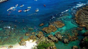 A coastal area with rocky terrain, clear water, and a sandy beach. - Gala Villa (Hengchun)