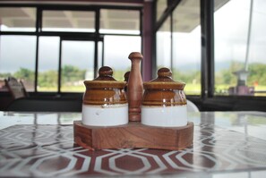 A table with a glass top and a wooden base, featuring a geometric pattern.