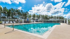 A rectangular swimming pool with a metal fence, lounge chairs, and a clear sky. - Ffv8438ha - Highlands Reserve - 4 Bed 2.5 Baths Villa (Davenport)