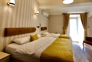 Standard Triple Room | Desk, blackout curtains, soundproofing, iron/ironing board