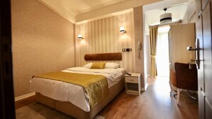 A bedroom with a bed, bedside table, and a wardrobe.