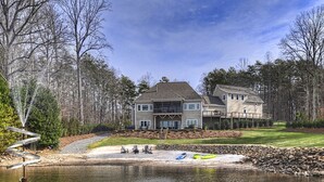 A large house with a deck and a pond in front. - Bridlewood Cove (Mooresville)