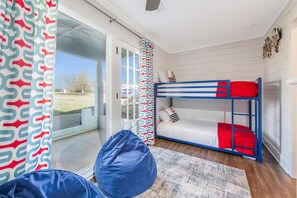 A room with a bunk bed, a bean bag chair, and a patterned curtain. - Points End (Mooresville)