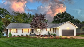 A single-story house with a front porch, a garage, and a well-maintained lawn. - Southern Sunrise (Mooresville)