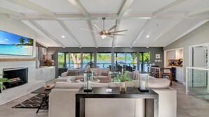 A spacious living room with a large sectional sofa, a fireplace, and a view of the outdoors. - Southern Sunrise (Mooresville)