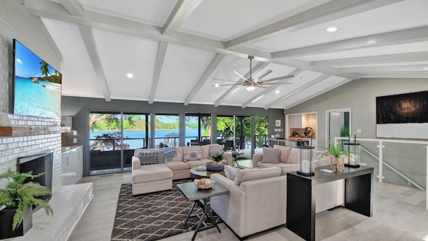 A spacious living room with a fireplace, comfortable seating, and a view of the outdoors. - Southern Sunrise (Mooresville)
