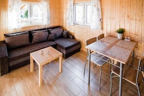 Relax in this inviting room with a sofa, coffee table, and dining area.