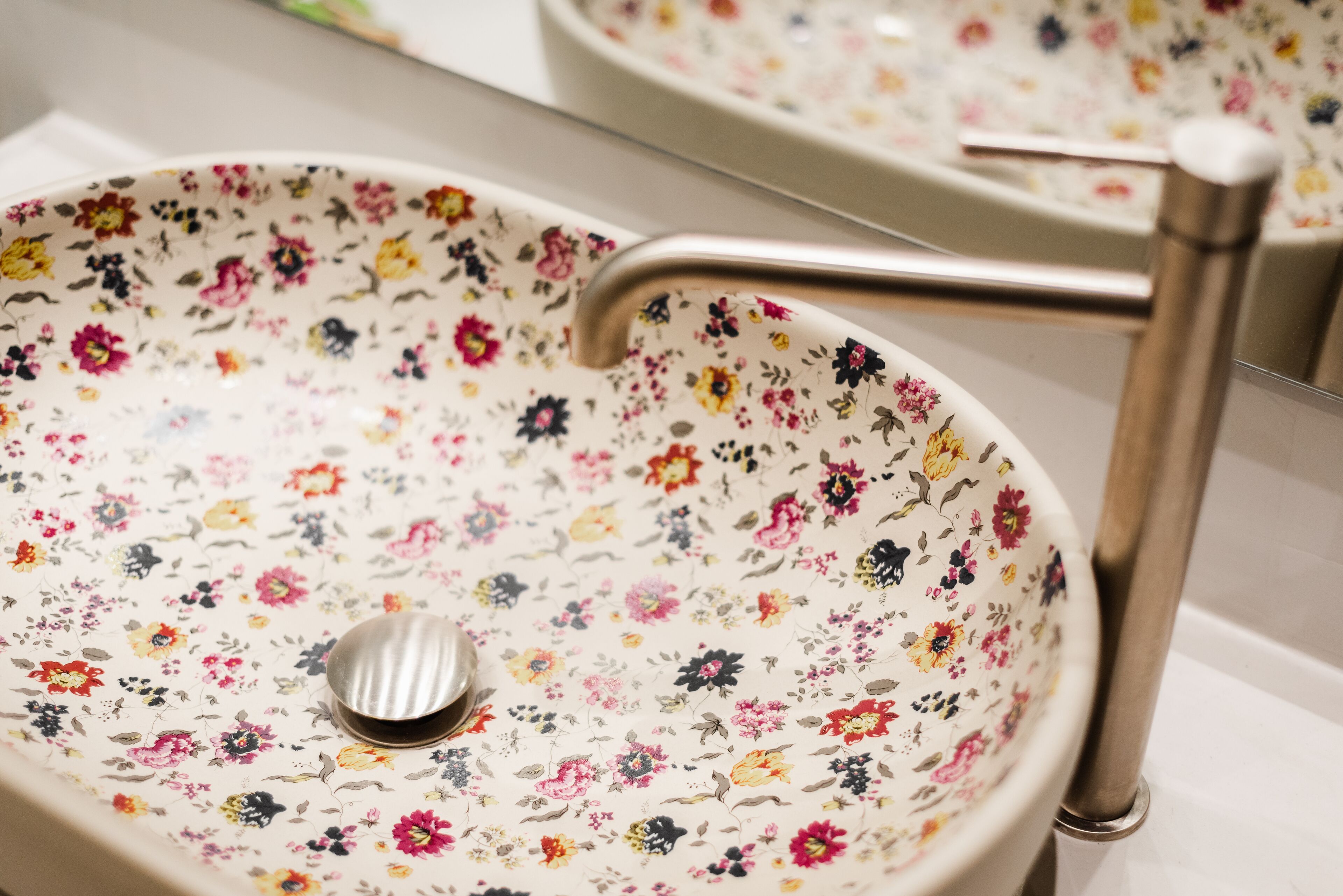 A bathroom sink with a floral pattern.