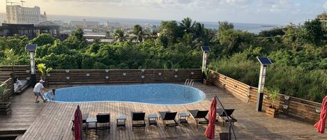 Outdoor pool, open 9:00 AM to 9:00 PM, pool umbrellas