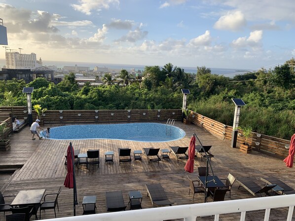 Outdoor pool, open 9:00 AM to 9:00 PM, pool umbrellas