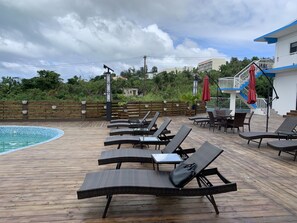 Outdoor pool, open 9:00 AM to 9:00 PM, pool umbrellas