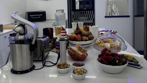 A kitchen with a coffee machine, toaster, and various food items on the counter. - Al Campanile (Sant'Agnello)