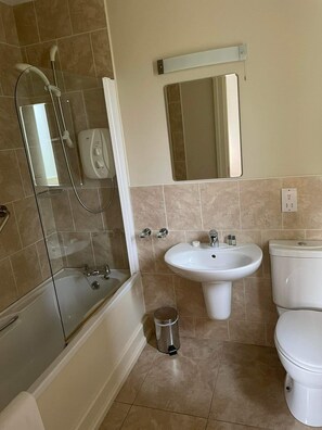 A bathroom with a bathtub, a sink, a toilet, and a shower. - Dunkerron Woods 3 Bedroom 4024 (Kenmare)