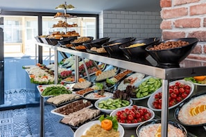 A buffet with various food items including salads, meats, and desserts. - Interstar Hotel (Istanbul)
