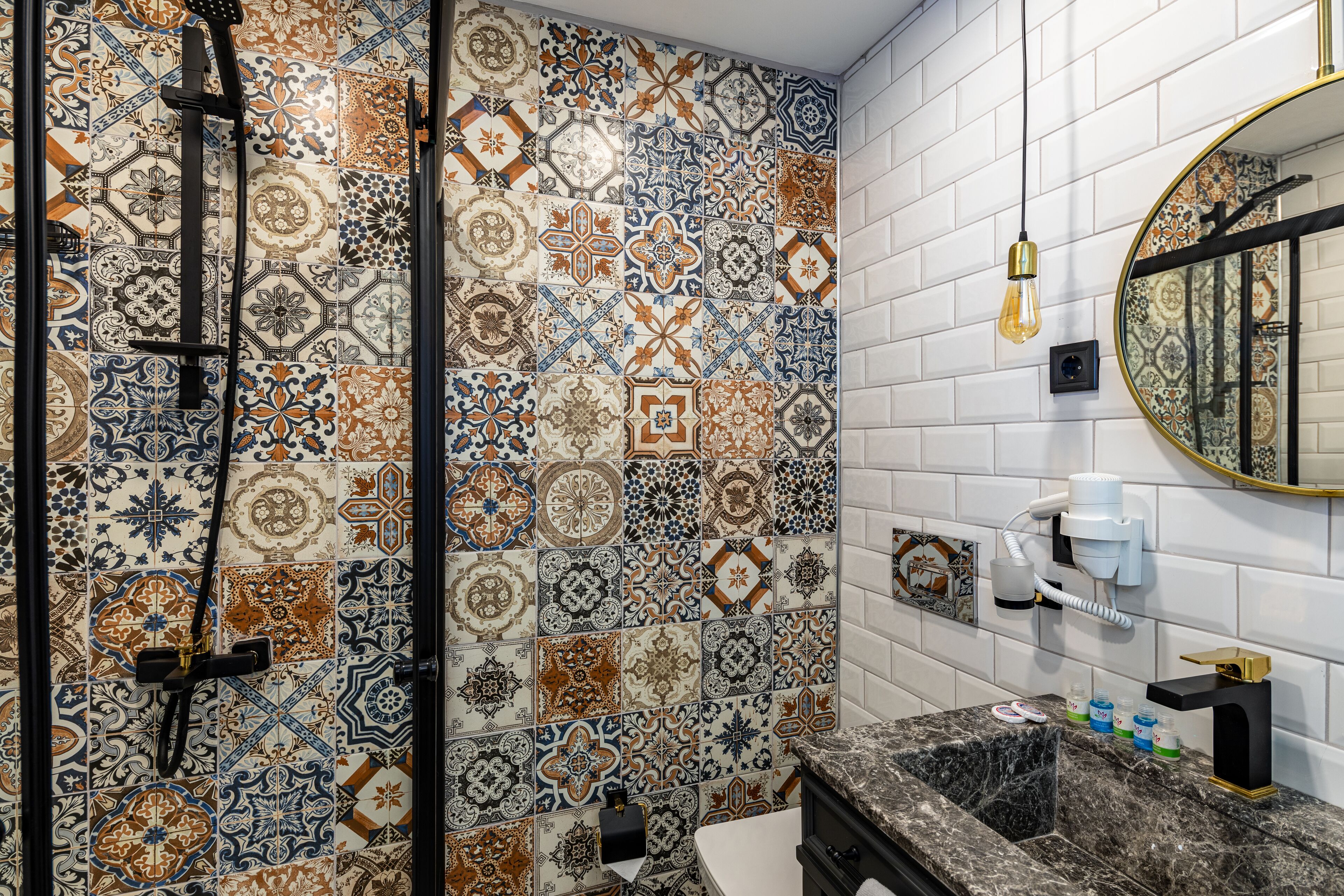 A bathroom with a shower, a sink, and a mirror.