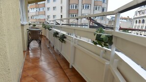 A balcony with tiled flooring, white railings, and potted plants. - Victoriei 7 - 2 bedroom apartment downtown (Sector 1)