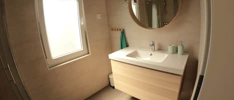 Shower, hair dryer, slippers, towels