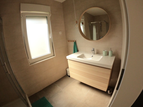 Shower, hair dryer, slippers, towels