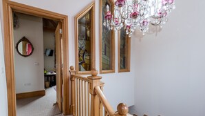 A staircase with wooden railings and a chandelier. - Mere Brook House (Wirral)