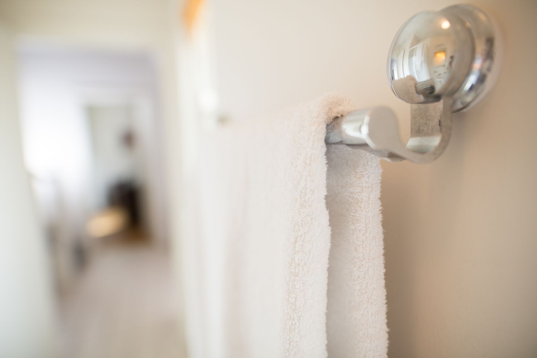 A close-up of a towel hanging on a door handle.