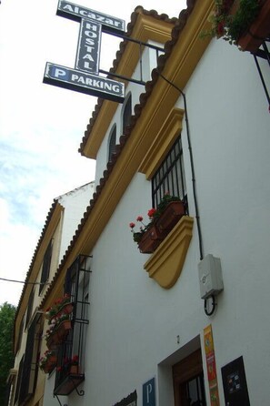 A building with a sign indicating 'Alcazar Hostal' and 'PARKING'. - Hostal Alcazar I (Córdoba)