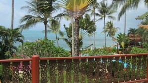A balcony with a view of the ocean, surrounded by palm trees and tropical plants. - 4 Bedroom Villa 4 SDV025-By Samui Dream Villas (Koh Samui)