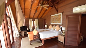 A bedroom with a wooden ceiling, a bed with pillows, a nightstand, a TV, and a window with curtains. - 3 Bedroom Beach Front Villa with Private Pool - P3 SDV026-By Samui Dream Villas (Koh Samui)