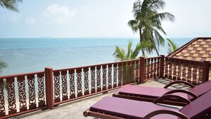 A balcony with a decorative railing overlooking a beach. - 3 Bedroom Beach Front Villa with Private Pool - P3 SDV026-By Samui Dream Villas (Koh Samui)