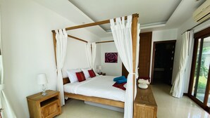 A four-poster bed with white curtains, a wooden nightstand, a bedside table with a lamp, and a blue bowl on the floor. - 3 Bedroom Villa - just 3 minutes walk to the beach SDV033-By Samui Dream Villas (Koh Samui)