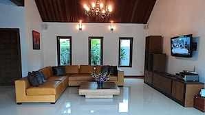 A spacious living room with a large sectional sofa, a coffee table, and a television mounted on the wall. - 3 Bedroom Villa - just 3 minutes walk to the beach SDV033-By Samui Dream Villas (Koh Samui)