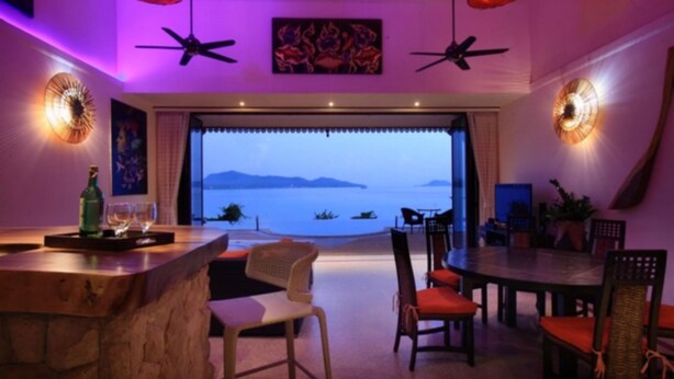 A dining area with a view of the sea, featuring a bar, chairs, and a table. - 8 Bedroom Sea Front Twin Villa Koh Phangan SDV231/234-By Samui Dream Villas  (Ko Pha-ngan)