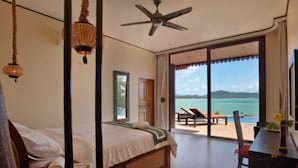 A bedroom with a bed, a ceiling fan, and a view of the sea through large sliding doors. - 8 Bedroom Sea Front Twin Villa Koh Phangan SDV231/234-By Samui Dream Villas  (Ko Pha-ngan)